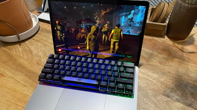 Shadow of the Tomb Raider being played in a Mac with adapted keyboards.