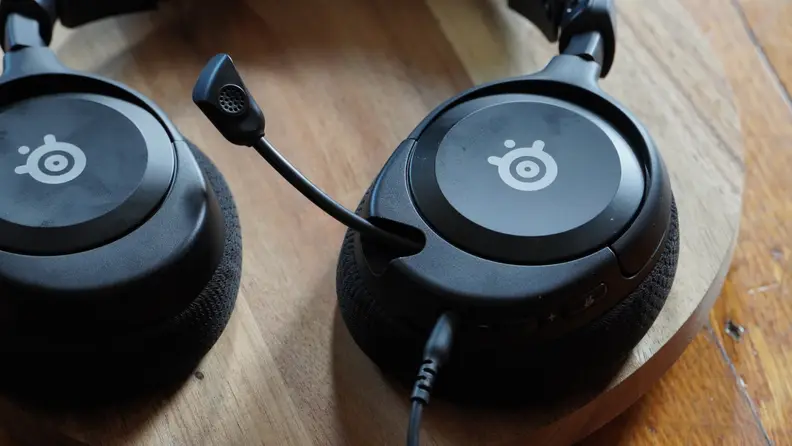 A microphone arm sticks out of SteelSeries headphones.