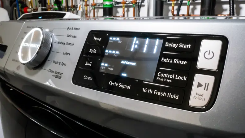 The control panel of the Maytag MHW6630HC front-load washer. Next to a giant cycle selection dial that reads, in all-caps, "EXTRA POWER," is a touch panel with more nuanced controls like temperature and water level selection.