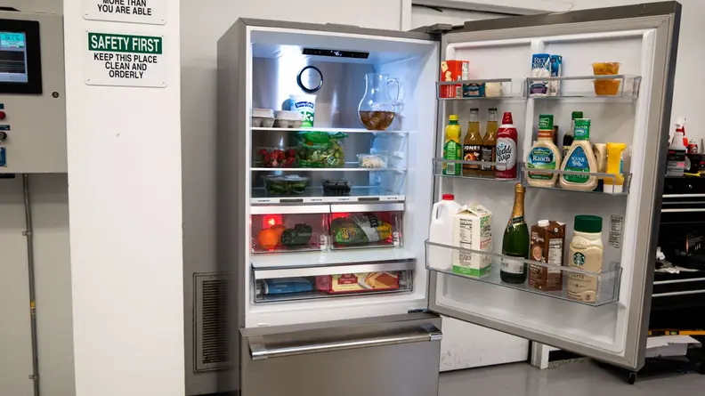 Assorted chilled foods stored inside of the Beko BFBD30216SSIM Bottom-freezer Refrigerator on shelves and inside of door storage.