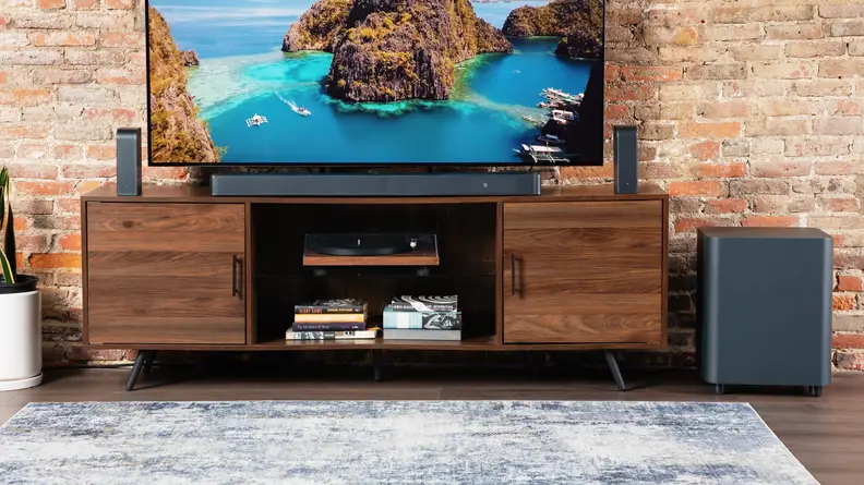 A TV entertainment center featuring the JBL Bar 1300X on the TV console center.