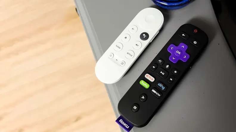 The Google Chromecast with Google TV remote next to the Roku remote