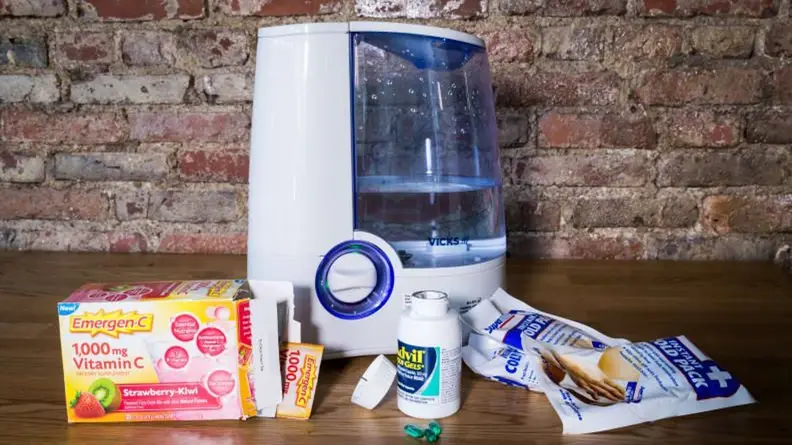 A Vicks 24-Hour Humidifier, surrounded by Emergen-C, Advil, and cold packs.