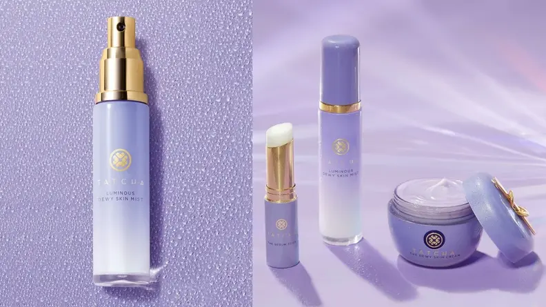 On the left: The Tatcha Luminous Dewy Skin Mist lays on a purple background in its cylindrical tube. On the right: The Tatcha mist stands on a purple background next to a moisturizer and lip balm from the brand.