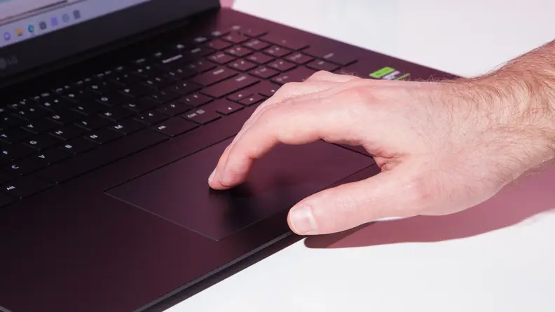 A man touching the mouse pad on the LG gram Pro 17 laptop.