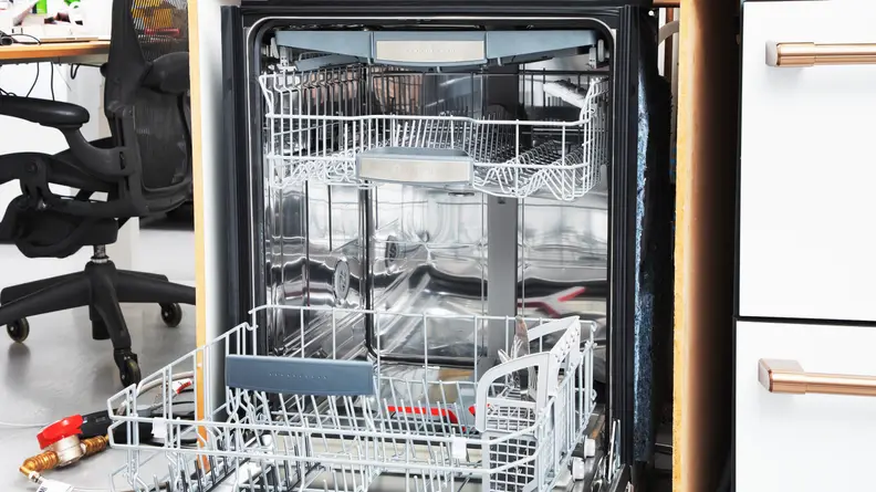 The Bosch SHP78CM5N with the door open, and dishes on a the top and bottom rack.