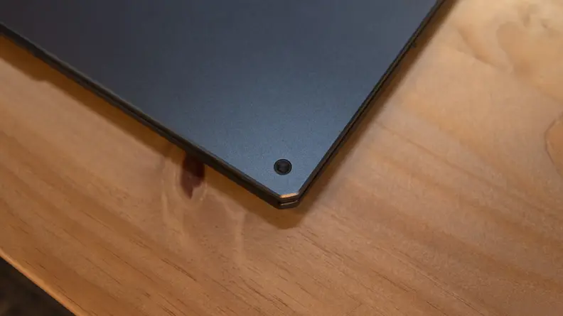 A closeup of a cosmetic screw on the lid's top