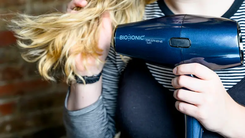 Person using a Bio Ionic hair dryer
