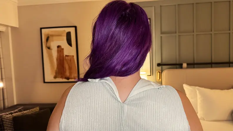 Close-up photograph of the back of a tank top that is difficult to clasp.