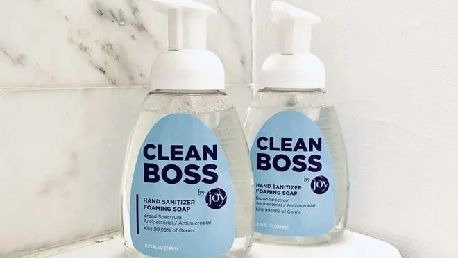 Two bottles of foaming hand soap on countertop.