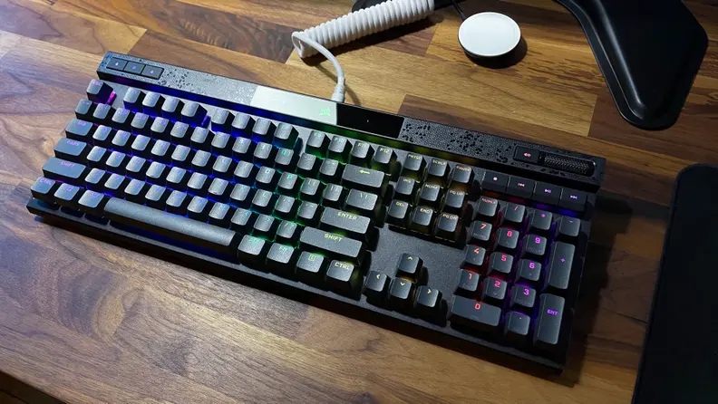 The corsair k70 Max rgb, one of the best gaming keyboards, lit up with RGB lighting and connected with a white cable