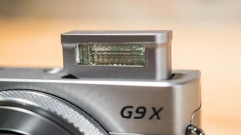 The G9 X doesn't have a viewfinder, but it does feature a pop-up flash.