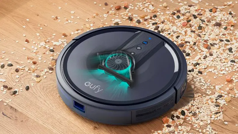 A robot vacuum sucks up crumbs.