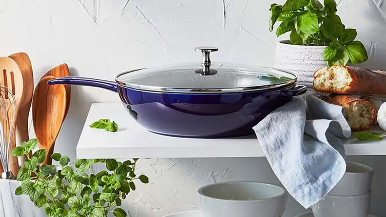 A blue pan sits on a countertop surrounded by kitchenware.