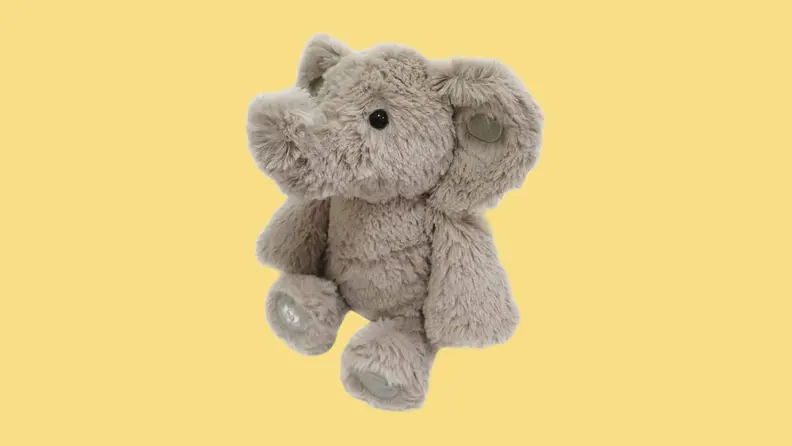 An elephant stuffed animal on a yellow background.