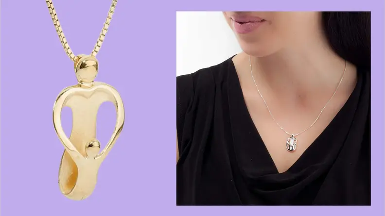 A Loving Family heart-shaped pendant in gold where the heart shape is created by what looks like two two people's arms connecting.
