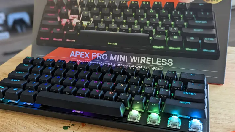A mechanical keyboard lit up from underneath each key in a rainbow of colors