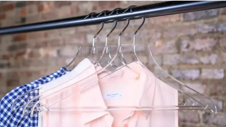 Clothing hanging from clear plastic hangers