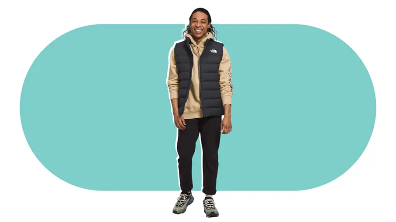A model wearing a black puffer vest.