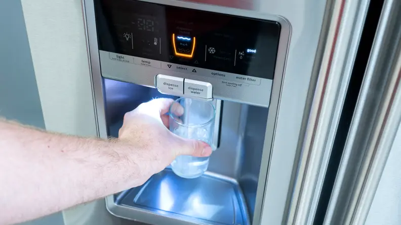 Water and ice are dispensed from the door