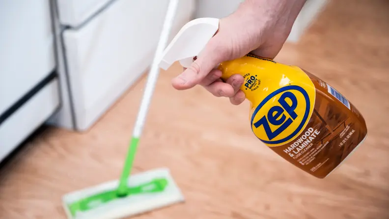 a person sprays Zep hardwood floor cleaner on a floor