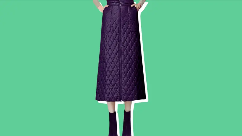 A model wearing a black quilted puffer midi skirt.