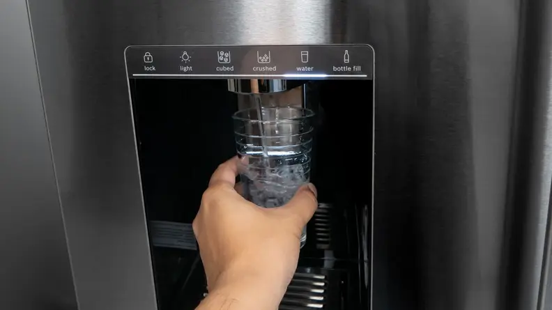 A close-up of a Bosch refrigerator's through-the-door ice and water dispenser.