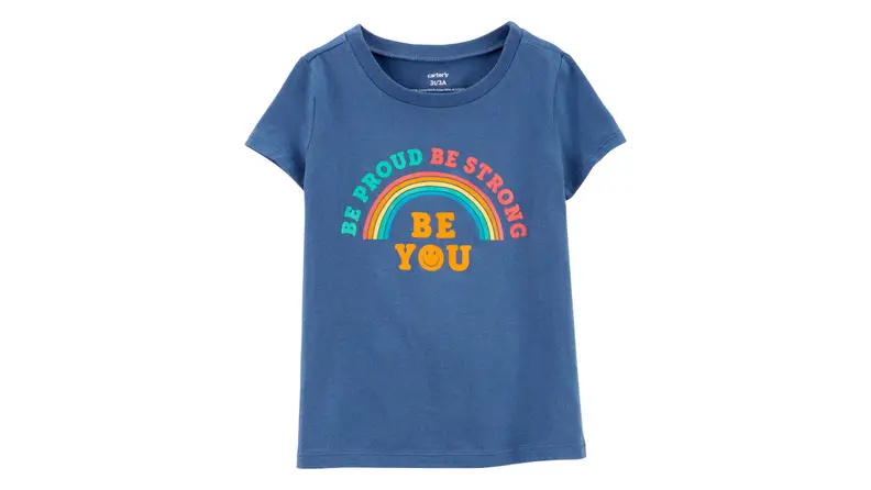 Blue tshirt on a white background with a rainbow across it that says "Be Proud Be Strong Be You"