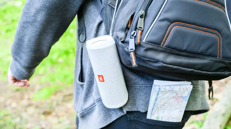 JBL speaker attached to a man with a backpack
