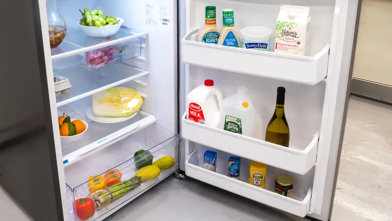 Peering into the main cavity of the Frigidaire FFHT1425VV,which is stocked with groceries.