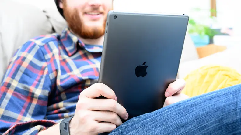 Man reading from a tablet