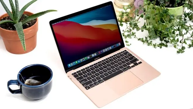 mug with tea in it and pink Apple MacBook Air