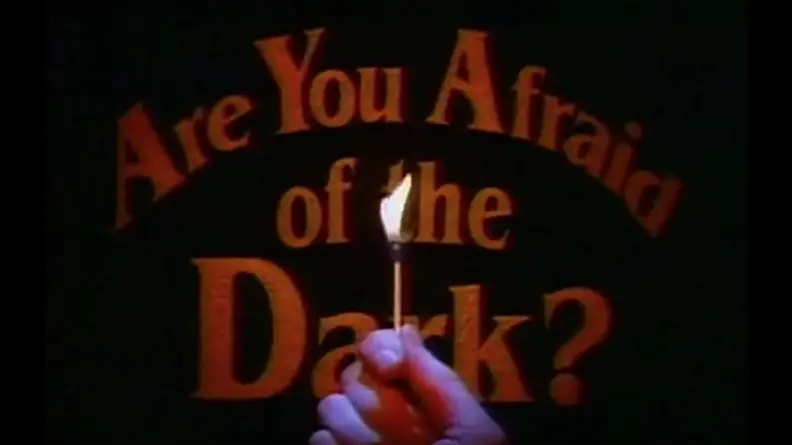 A hand holding a lit match, in front of the title 