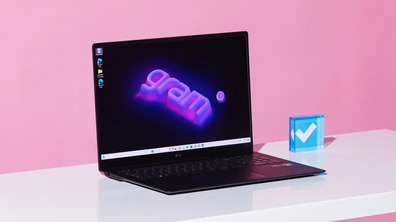 The LG gram Pro 17 laptop on a white desk with a pink background.