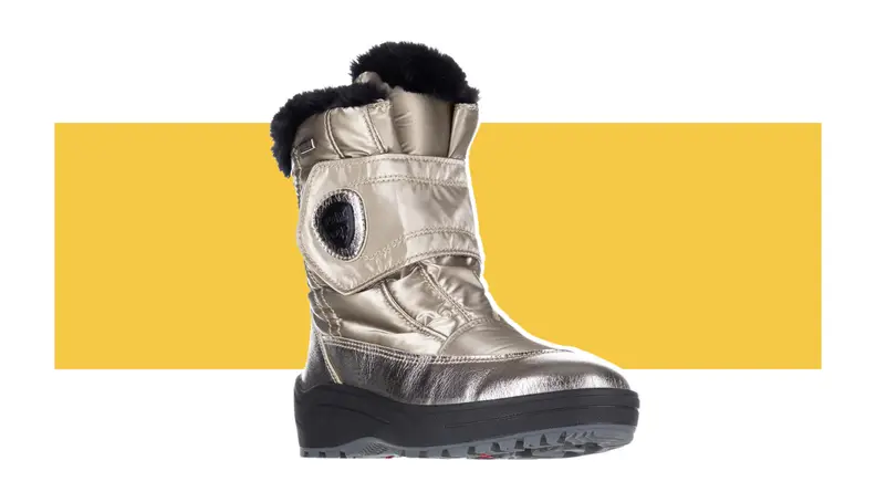 A pewter-colored boot with black lining and sole against a yellow background