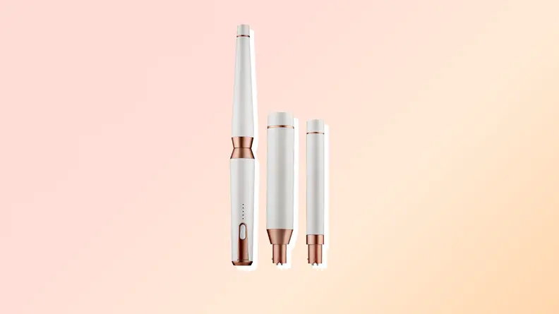 T3 Curling iron against a pink and orange background.