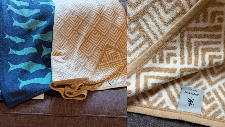 Two blankets drape side by side on a couch
