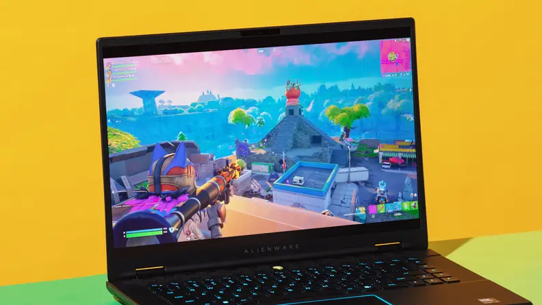 The Alienware m16 R2 gaming laptop with a video game scene on screen.