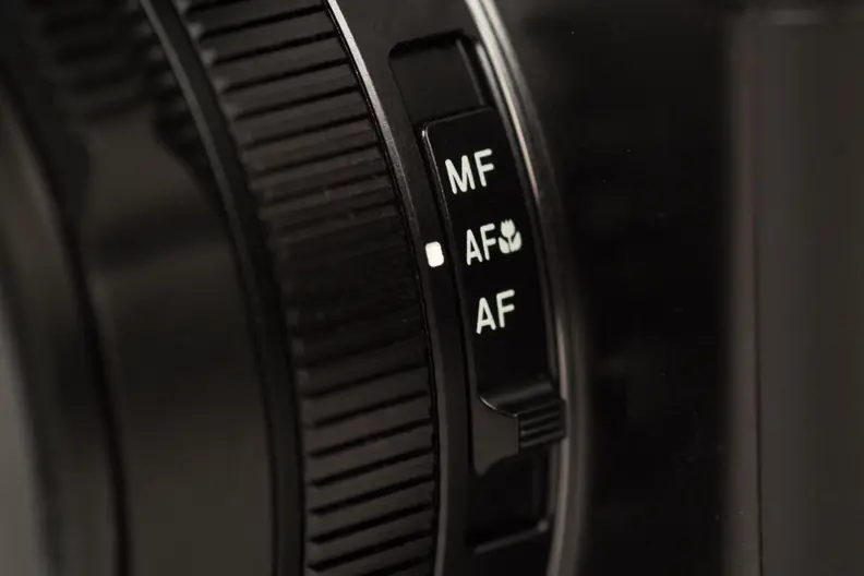 A photograph of the Panasonic Lumix LX100's focus switch.