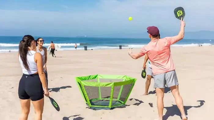 people playing game on beach