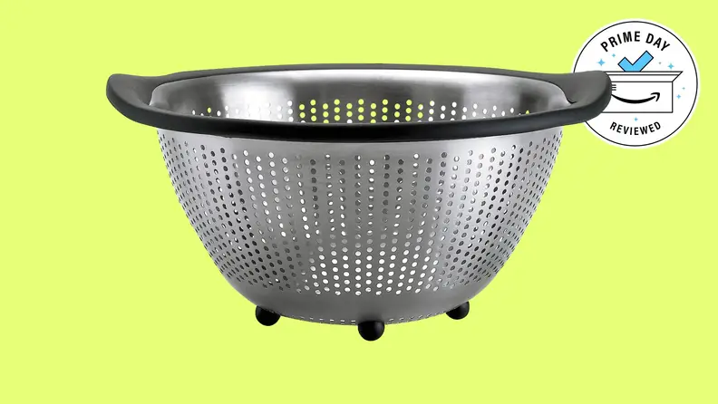 The OXO Good Grips Stainless Steel 5-Quart Colander against a yellow background.