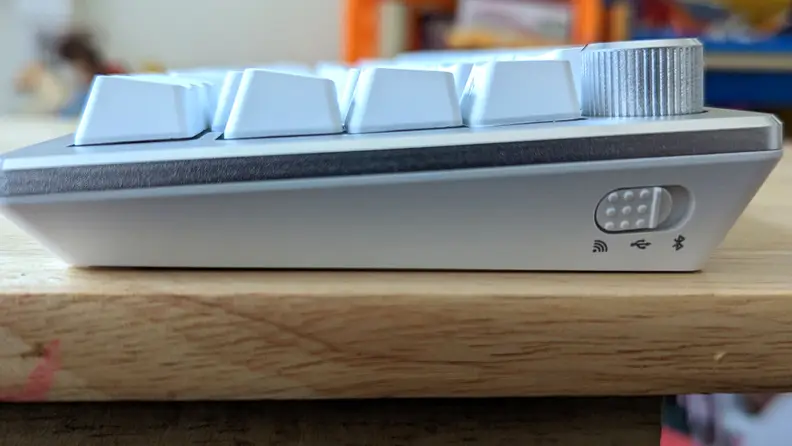 A close up view of the side of a white keyboard