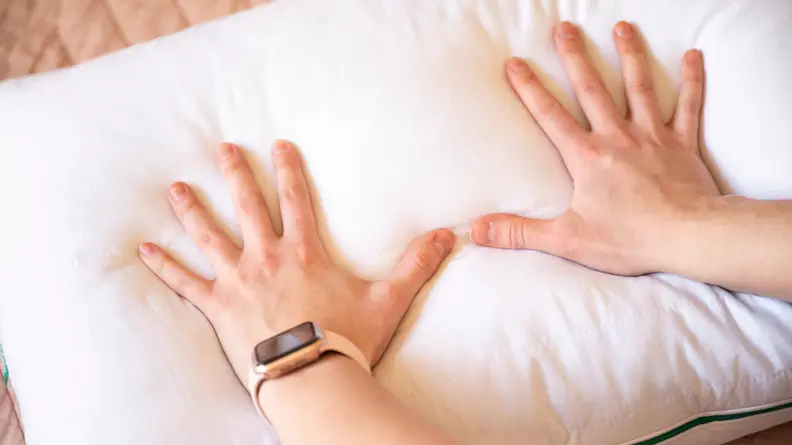 hands pressing down on Marlow Pillow