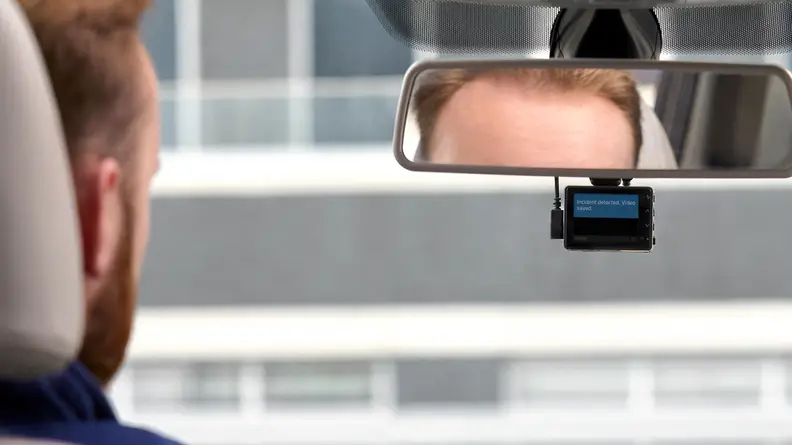 A driver glances at his vehicle's dash cam.