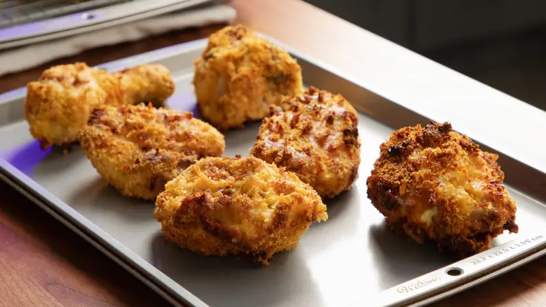 Sheet tray full of fried chicken thighs