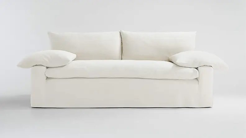 A white couch on a grey background.
