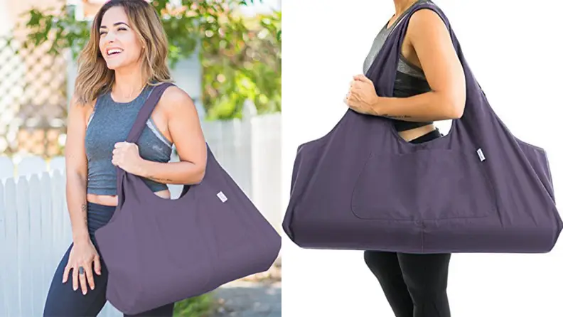Woman holding yogiii tote bag.
