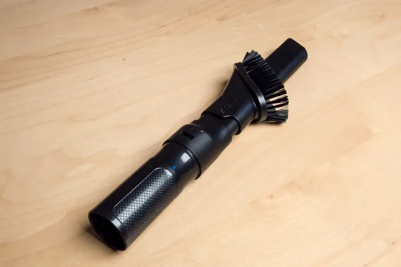 Almost all vacuums come with a crevice-dusting combination wand. The wand can be used to dust shelves and pick up crumbs on couches.