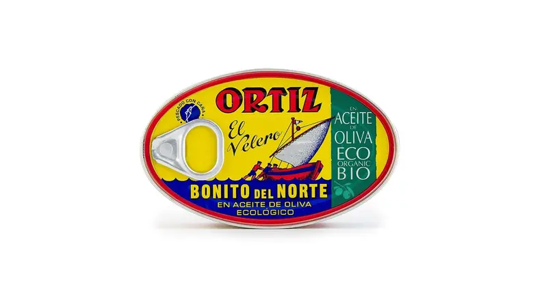 A tin of tuna in olive oil against a white background.
