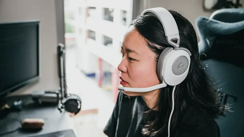 A person wears a white pair of headphones.